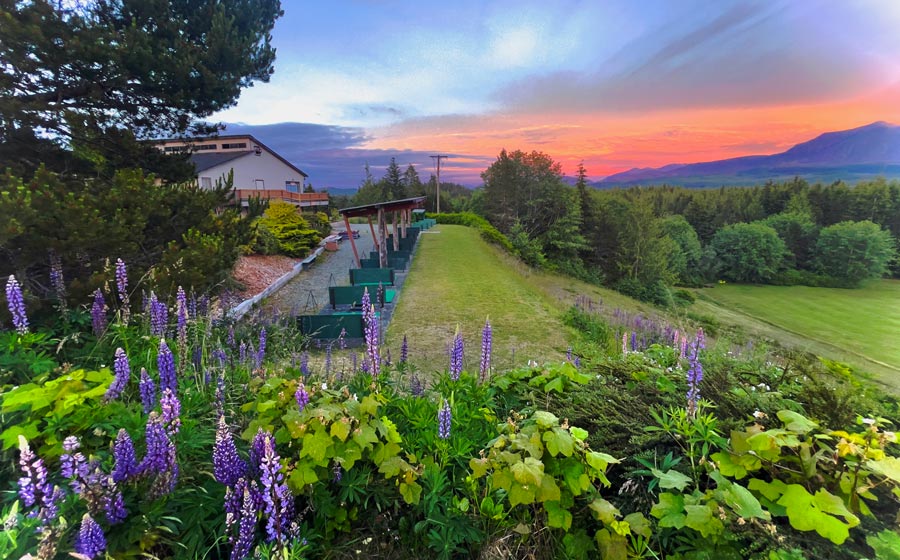sunset behind the driving range over the mountains at Seven Hills GCC